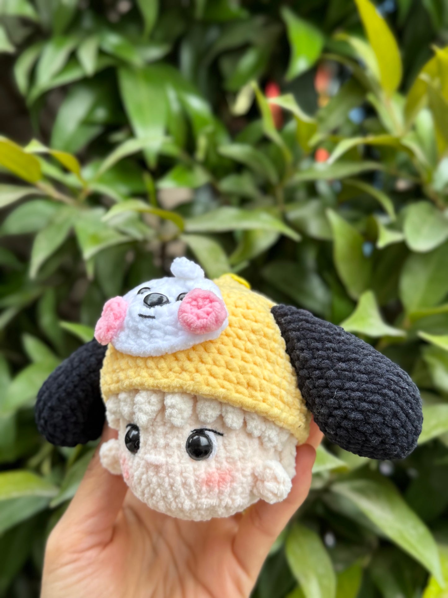 Hand holding BTS Jimin crochet keychain