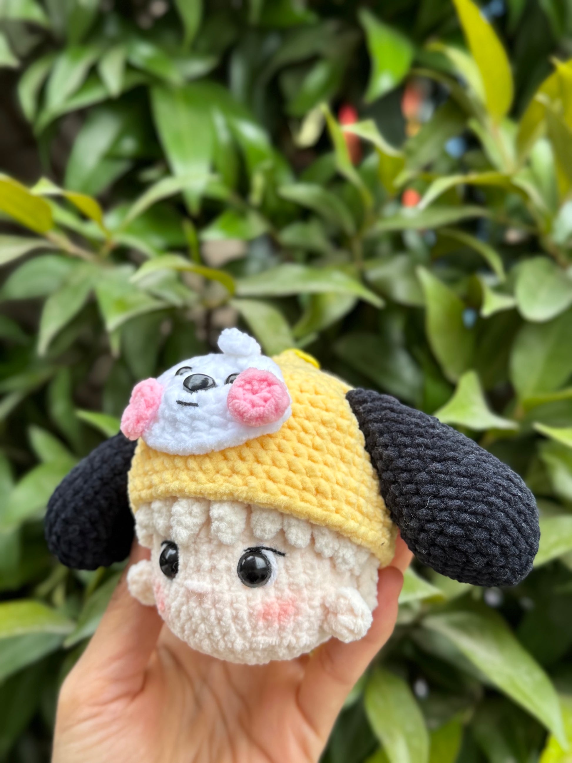 Hand holding BTS Jimin crochet keychain