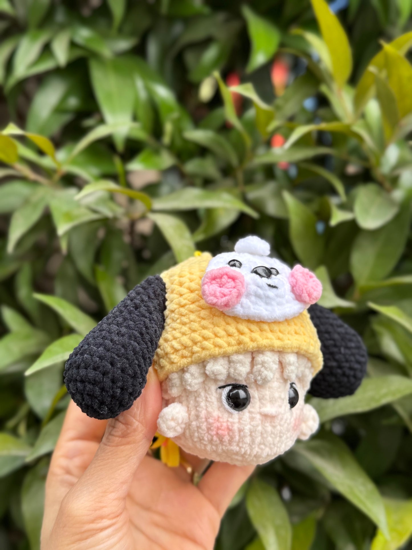 Hand holding BT21 Chimmy crochet keychain
