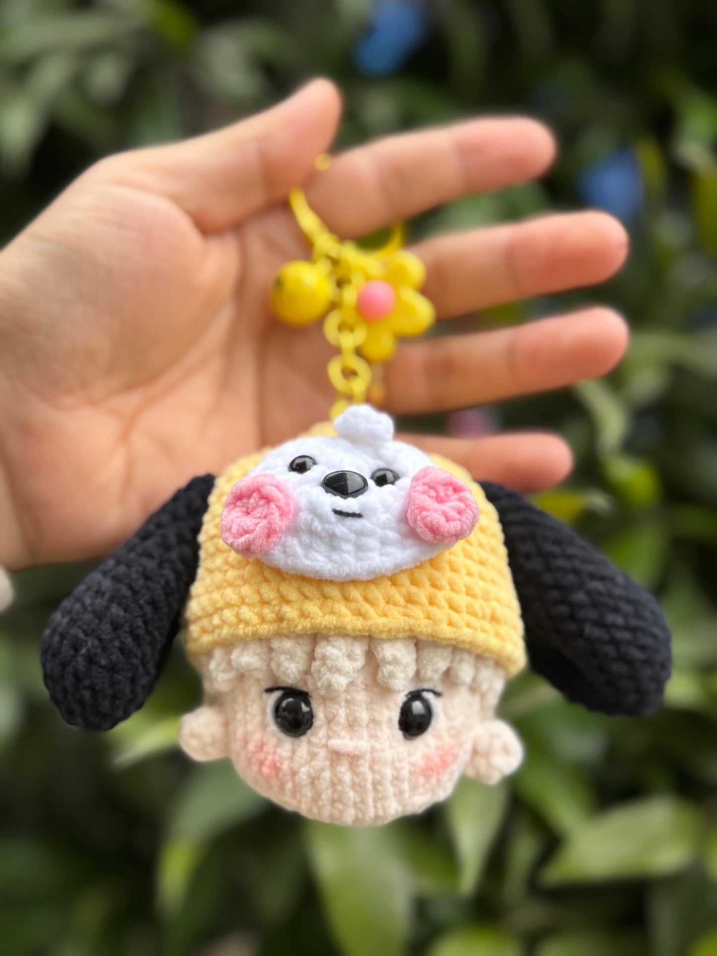 Hand holding a BTS keychain inspired by BT21 Chimmy character
