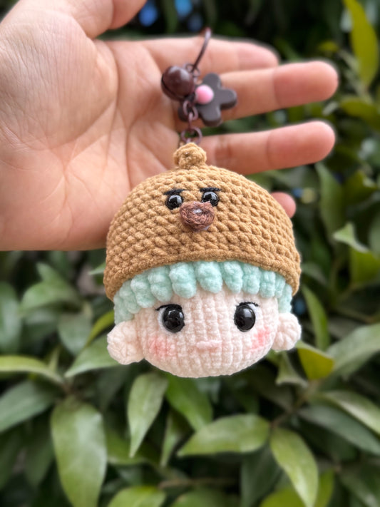 Holding BTS Suga crochet keychain, soft and small. Perfect keychain for handbag, backpack
