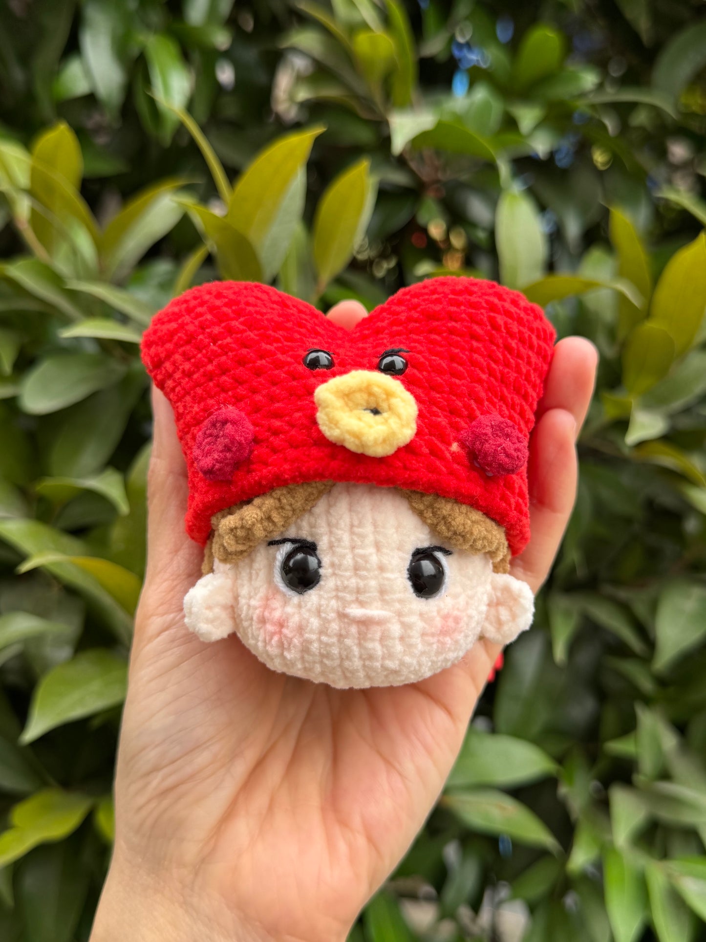 Hand holding BT21 Tata crochet keychain inspired by BTS V