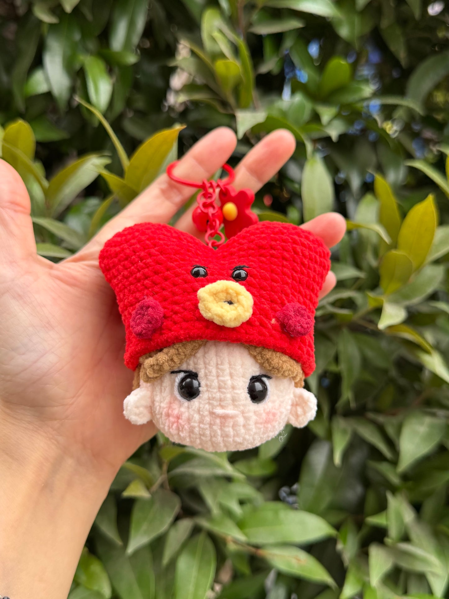 Hand holding BTS V crochet keychain
